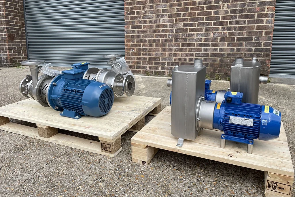 A picture of 2 Industrial Self Priming Centrifugal Pumps and 2 High Performance Self Priming Centrifugal Pumps on pallets in front of our website for Sump Pit Emptying applications