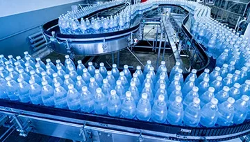 A photo of beverage bottles on a conveyor belt