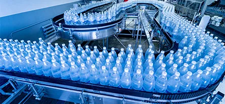 A photo of beverage bottles on a conveyor belt